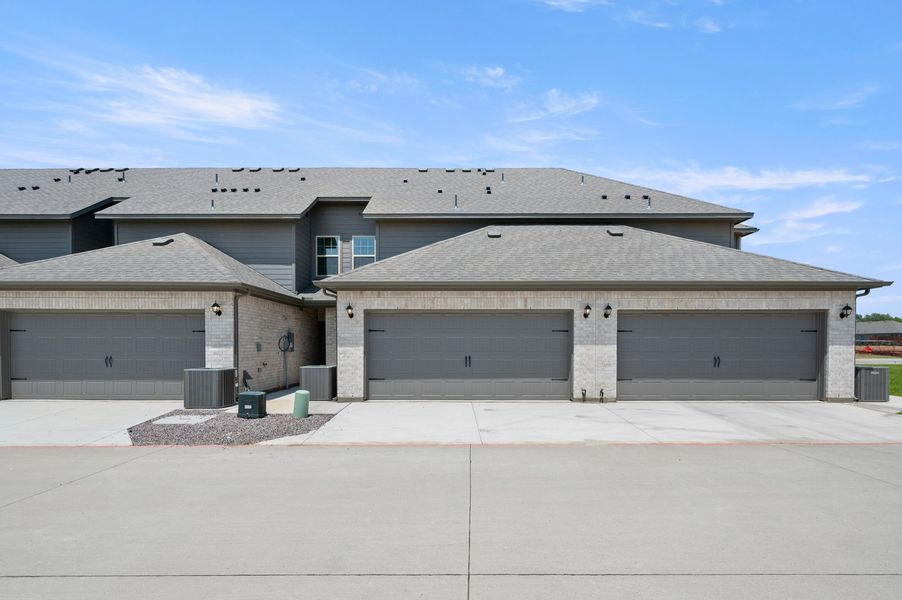Front exterior of a new home in Sanger Circle – Townhomes, Sanger, TX, highlighting curb appeal (Image 27). Front exterior of a new home in Sanger Circle – Townhomes, Sanger, TX, highlighting curb appeal (Image 27).