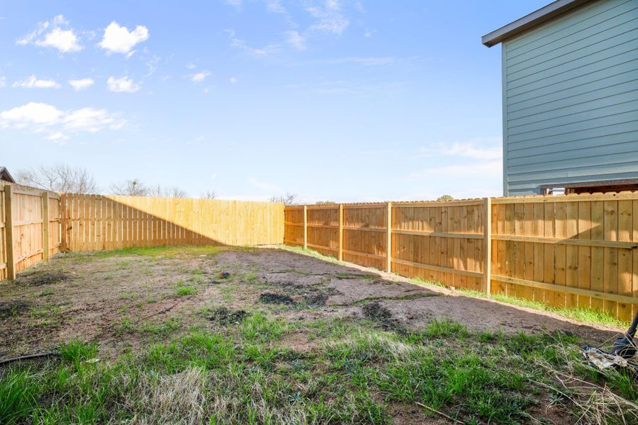 View of fenced backyard