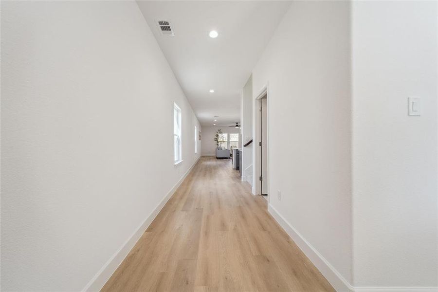 Corridor with light hardwood / wood-style floors