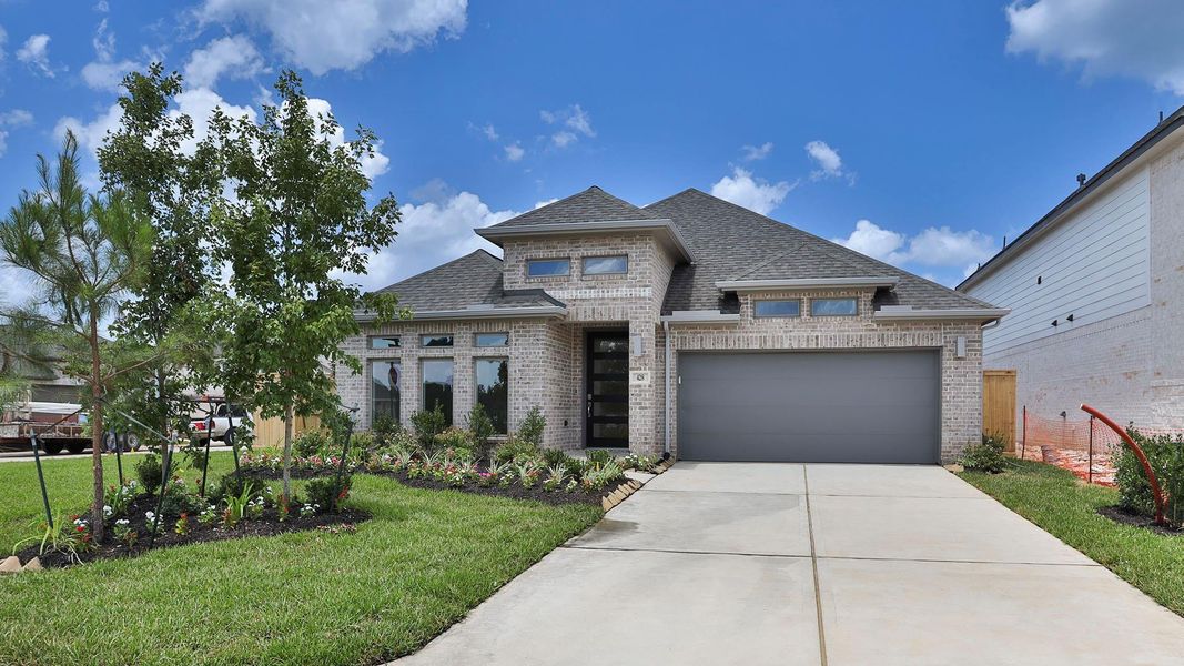 Front exterior of a new home in Grand Central Park 50', Conroe, TX, highlighting curb appeal (Image 2). Front exterior of a new home in Grand Central Park 50', Conroe, TX, highlighting curb appeal (Image 2).
