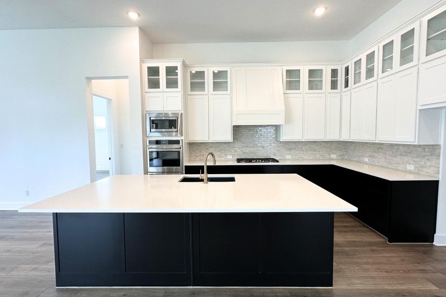 Culinary excellence awaits in this kitchen featuring a spacious island and gleaming stainless steel appliances.