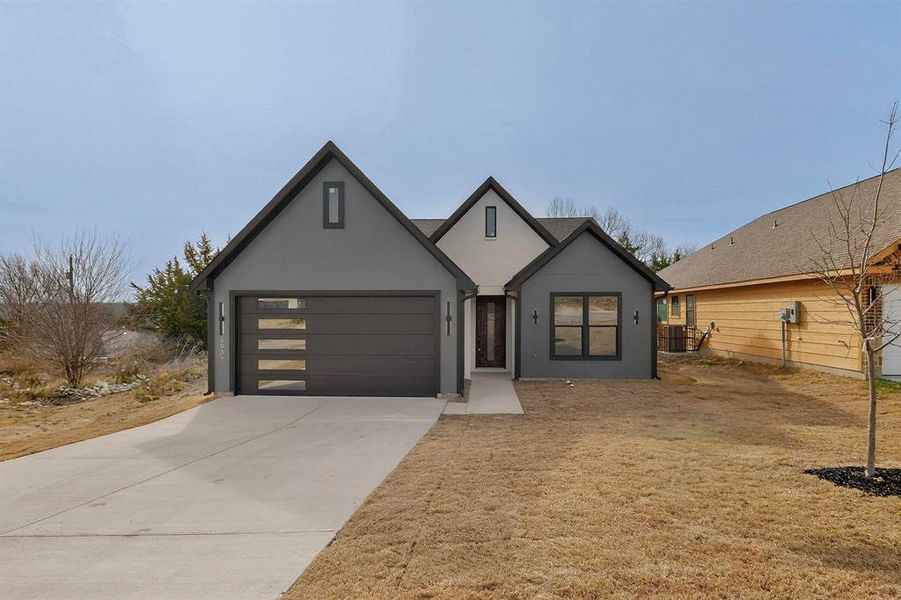 View of front of home with stucco siding, driveway, and a garage View of front of home with stucco siding, driveway, and a garage