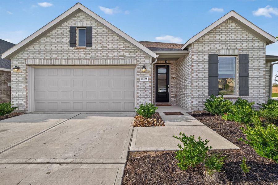 Front exterior of a new home in Sunterra, Katy, TX, highlighting curb appeal (Image 22). Front exterior of a new home in Sunterra, Katy, TX, highlighting curb appeal (Image 22).