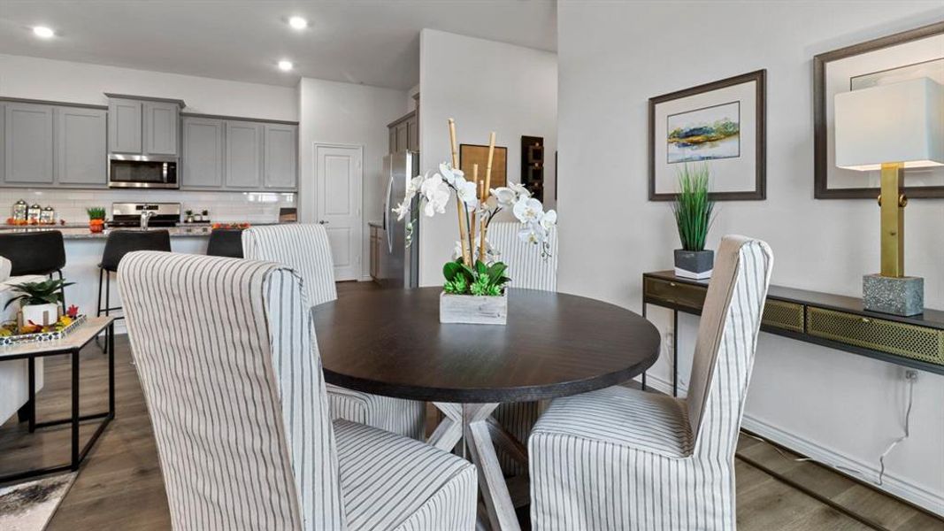 Dining room featuring dark wood-type flooring and recessed lighting
