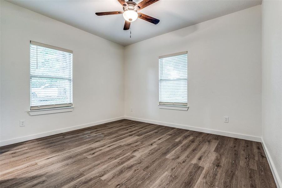 Spare room with hardwood / wood-style flooring and a wealth of natural light