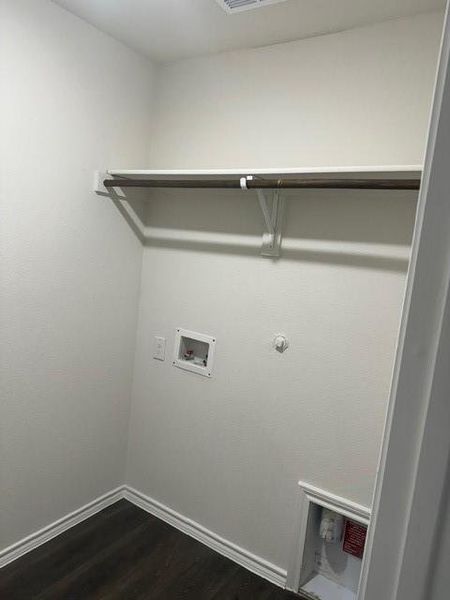 Laundry room featuring washer hookup, hookup for a gas dryer, and dark hardwood / wood-style flooring