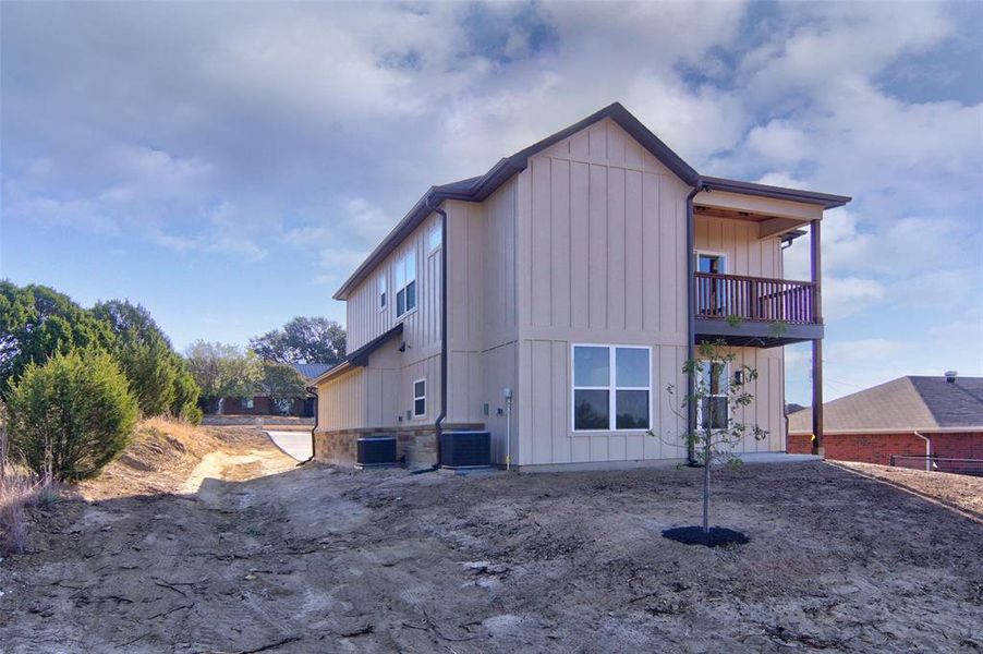 back yard view of the house with room to drive access, Balcony and covered back porch