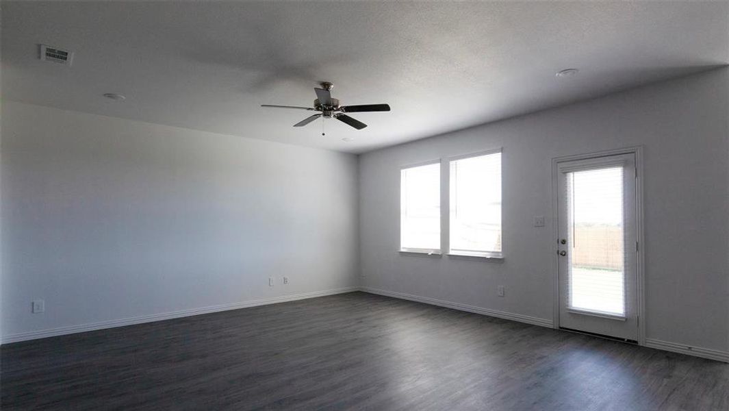 Unfurnished room featuring ceiling fan and dark hardwood / wood-style flooring