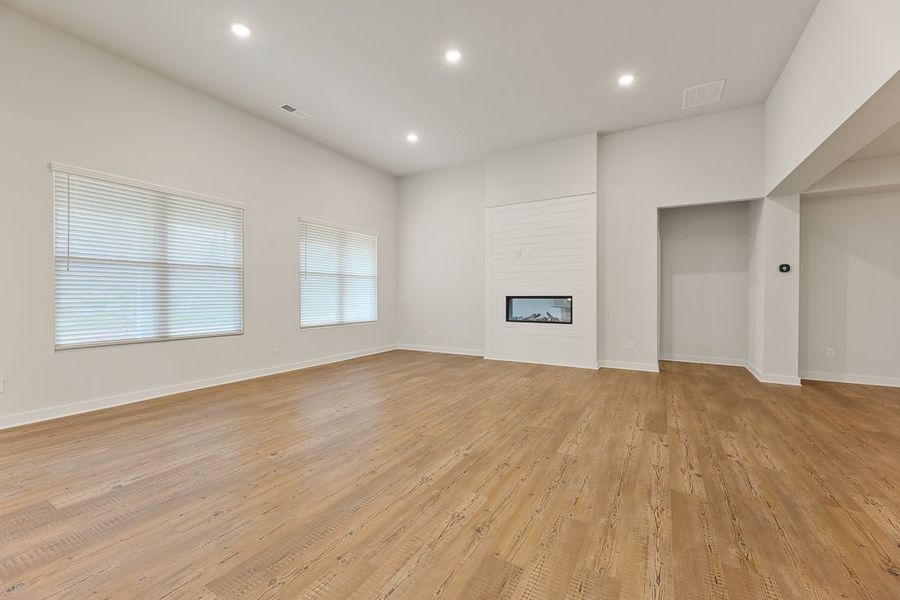 A room with a wood floor and white walls.