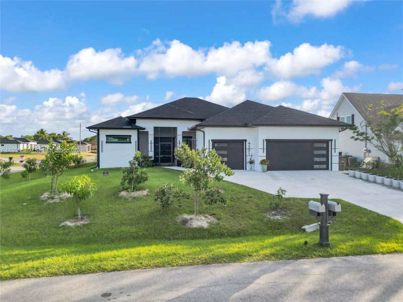 Front exterior of a new home in , Lehigh Acres, FL, highlighting curb appeal (Image 2). Front exterior of a new home in , Lehigh Acres, FL, highlighting curb appeal (Image 2).