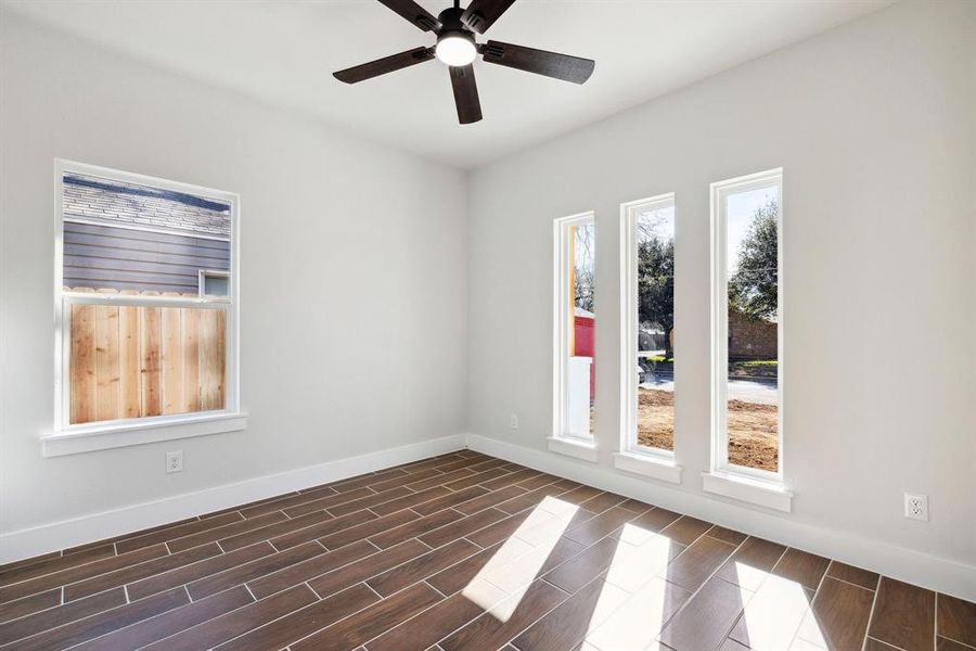 Empty room featuring ceiling fan and plenty of natural light