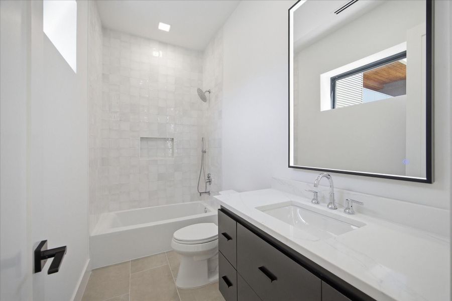 Crisp lines and curated finishes create a polished, modern bathroom experience in every suite.