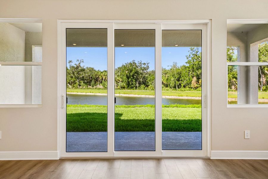 The family room looks out through the large sliding glass doors on to the pond view