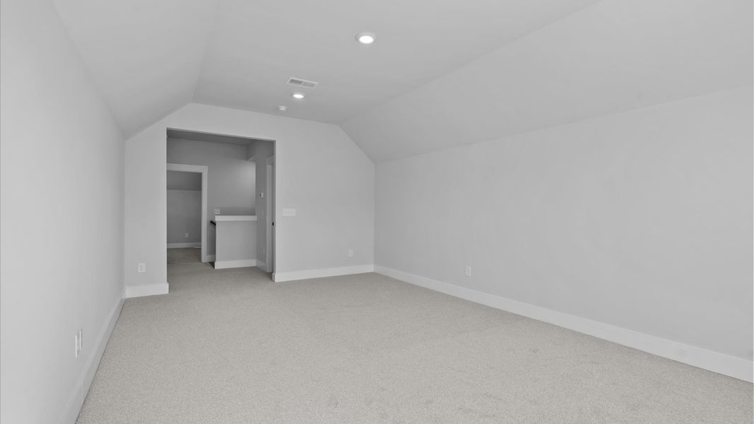 Elegant bedroom retreat featuring soft carpeting and a thoughtfully designed walk-in closet