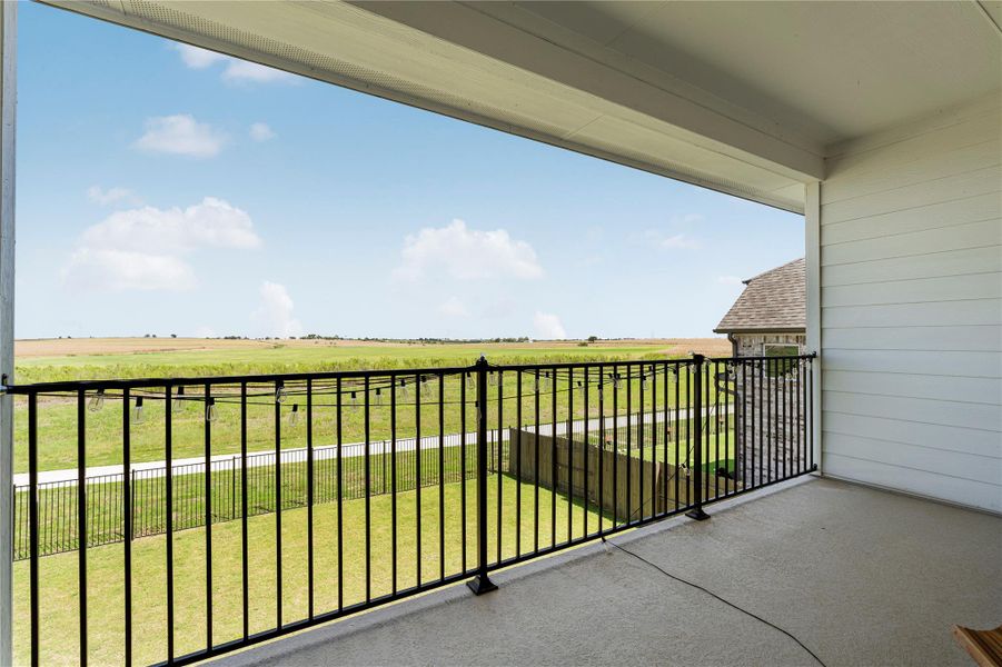 Enjoy sprawling countryside views from this elevated, covered balcony, perfect for serene outdoor moments. Enjoy sprawling countryside views from this elevated, covered balcony, perfect for serene outdoor moments.