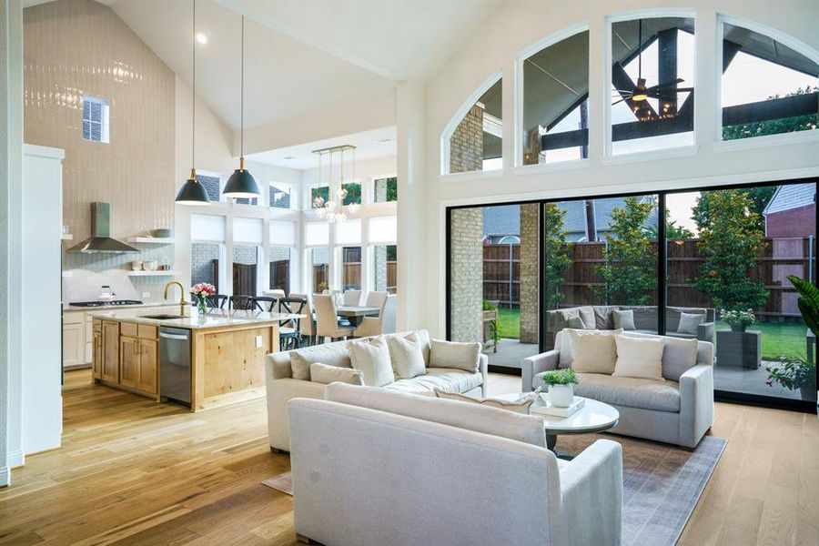 Light-Filled Open Concept - Natural light pours through clerestory windows and a 15' sliding door, blending indoor and outdoor living. This central hub connects the kitchen, dining, and living spaces in one flowing, functional layout. Light-Filled Open Concept - Natural light pours through clerestory windows and a 15' sliding door, blending indoor and outdoor living. This central hub connects the kitchen, dining, and living spaces in one flowing, functional layout.