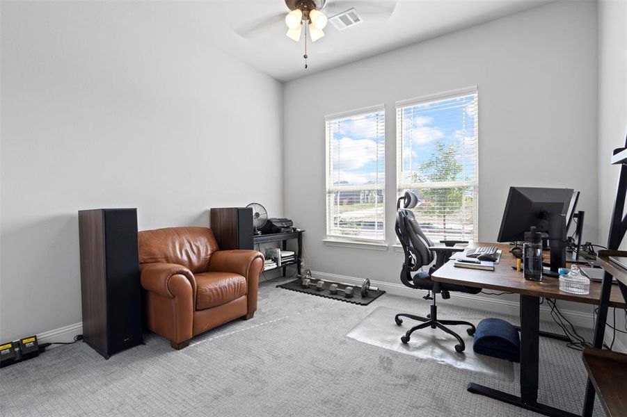 Office area featuring ceiling fan and light carpet