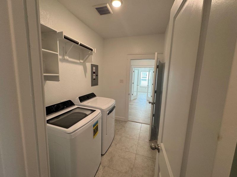 Washroom featuring light tile patterned floors and washing machine and clothes dryer Washroom featuring light tile patterned floors and washing machine and clothes dryer