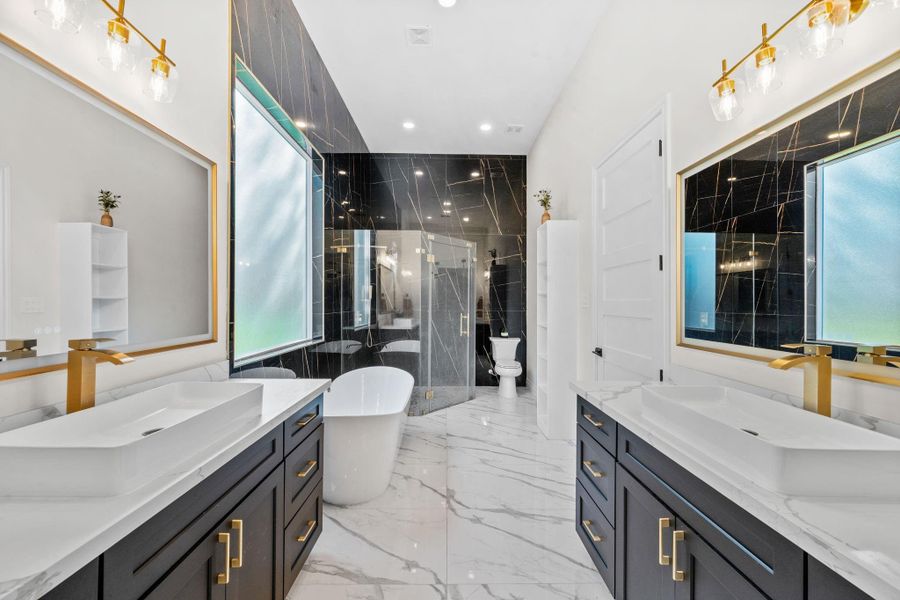 The primary bathroom has separate shower with beautiful tile to the ceiling, a soaking tub and two great size vanities.