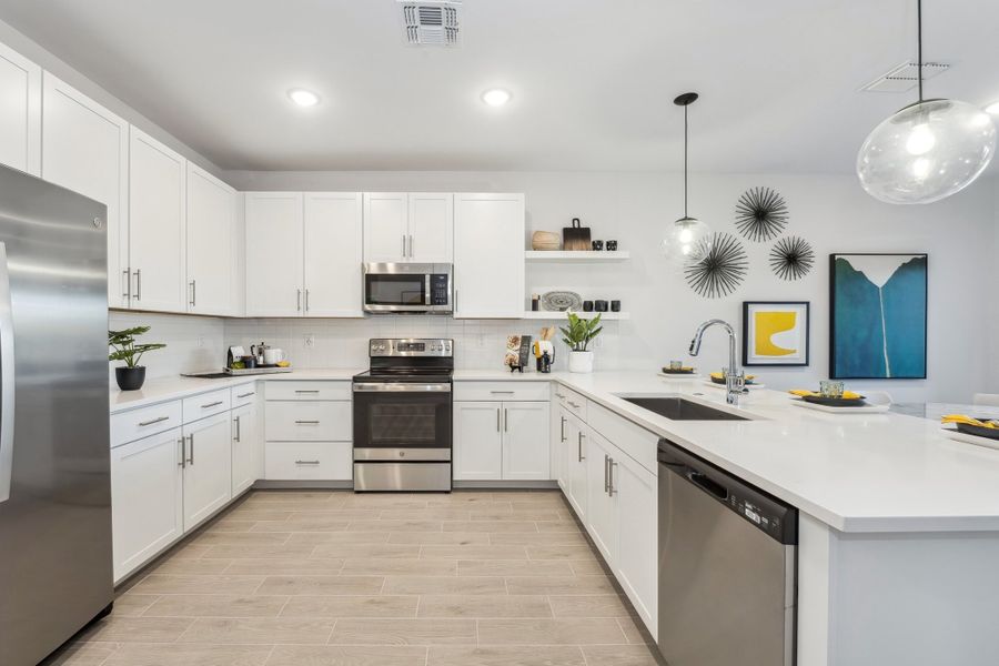 Stainless steel apron-front sink and chrome faucet