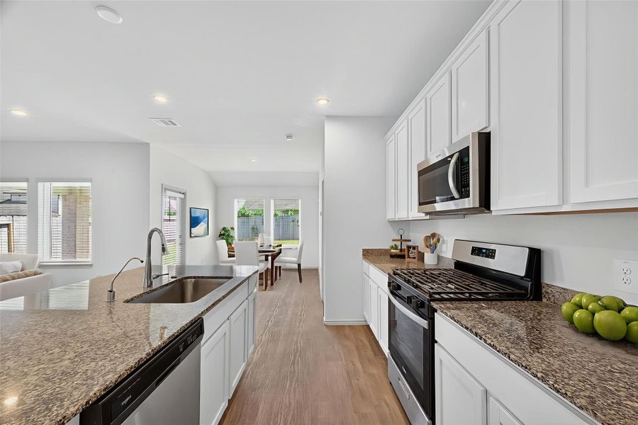 This oversized island is perfect for the chef of the home to prepare meals made with love. Its central location allows conversations to flow easily from the dining area to the living room, making it the heart of the home. This oversized island is perfect for the chef of the home to prepare meals made with love. Its central location allows conversations to flow easily from the dining area to the living room, making it the heart of the home.