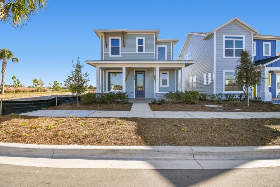 Front exterior of a new home in Weslyn Park in Sunbridge 34', St. Cloud, FL, highlighting curb appeal (Image 25).