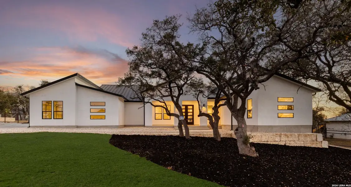 Front exterior of a new home in , Bulverde, TX, highlighting curb appeal (Image 23).