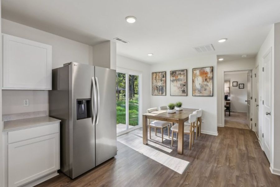 A kitchen with a dining table.