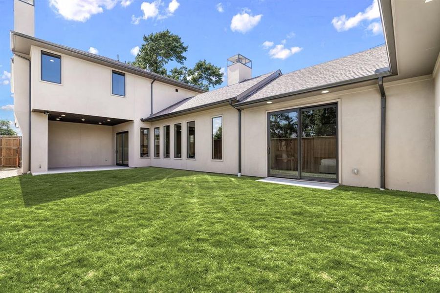 Back of property with a chimney, a patio, stucco siding, and roof with shingles Back of property with a chimney, a patio, stucco siding, and roof with shingles