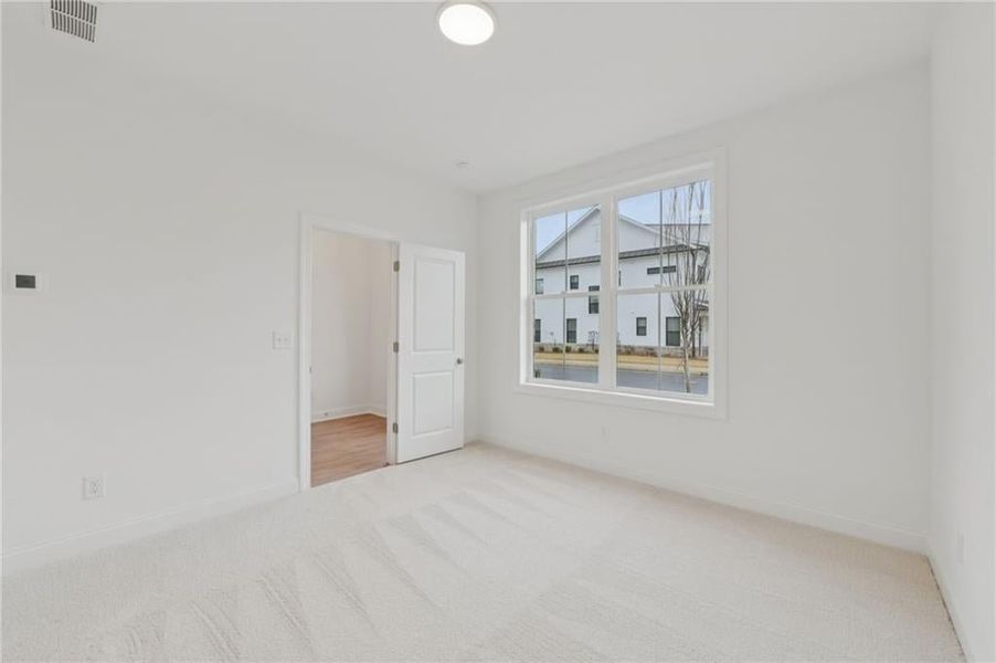 Bedroom on the main floor with its own bathroom - prewired and ready for a fan - Home is under construction and estimated to be completed in June/July 2026 
Pictures represent a previously built home not the actual home