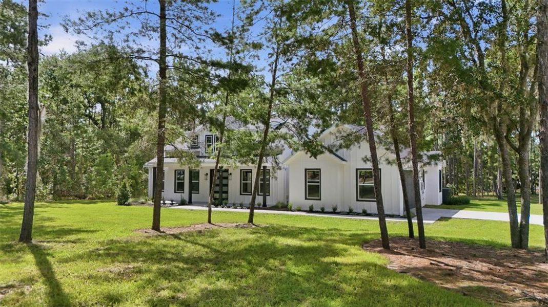 Front exterior of a new home in , Wildwood, FL, highlighting curb appeal (Image 27).