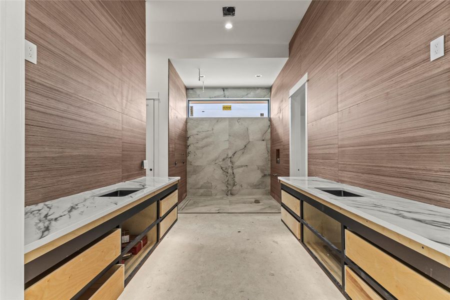 Contemporary bathroom featuring dual floating vanities with undermount sinks and stone countertops