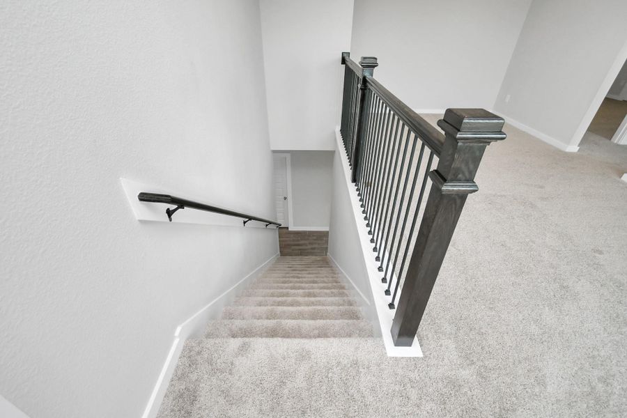 View from the stunning staircase. Sample photo of completed home with similar floor plan. Actual colors and selections may vary.