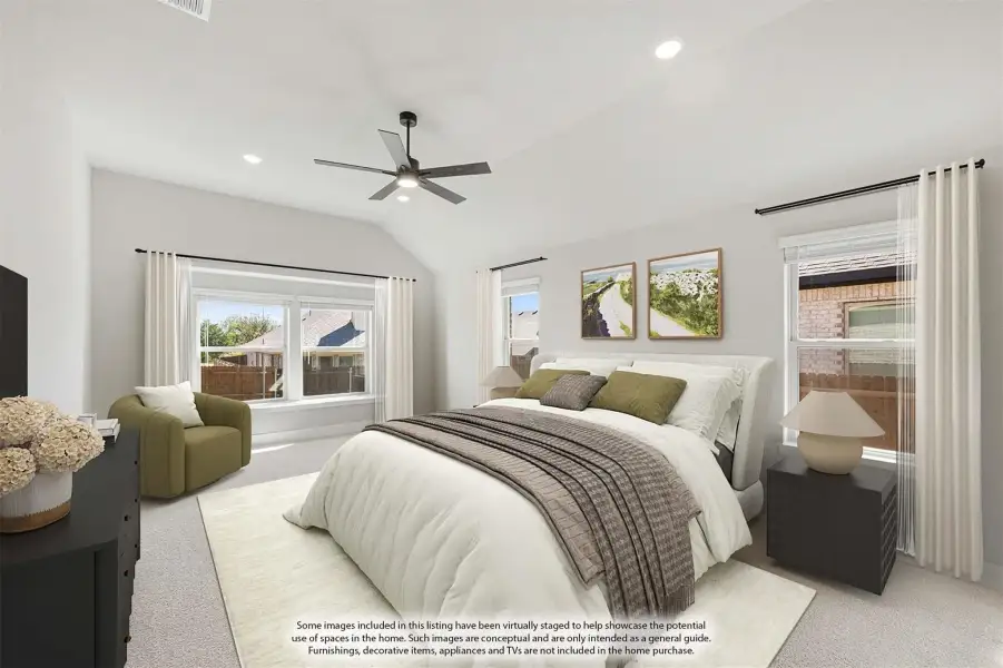 Spacious master bedroom with vaulted ceiling, ceiling fan, carpet flooring, and multiple windows