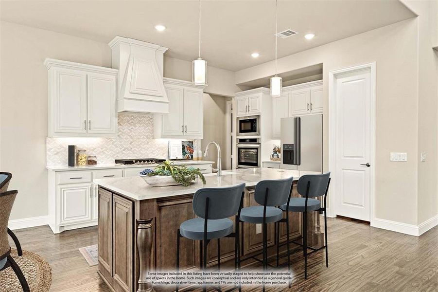 Kitchen featuring a center island with sink, white cabinetry, a breakfast bar area, backsplash, and light stone counters