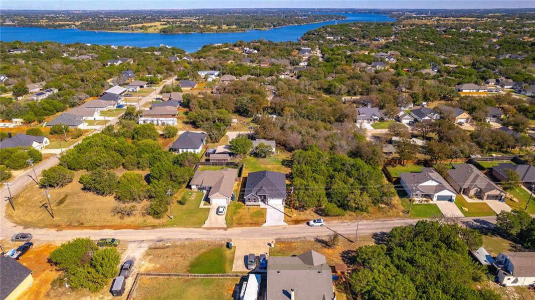 Birds eye view of property with a water view