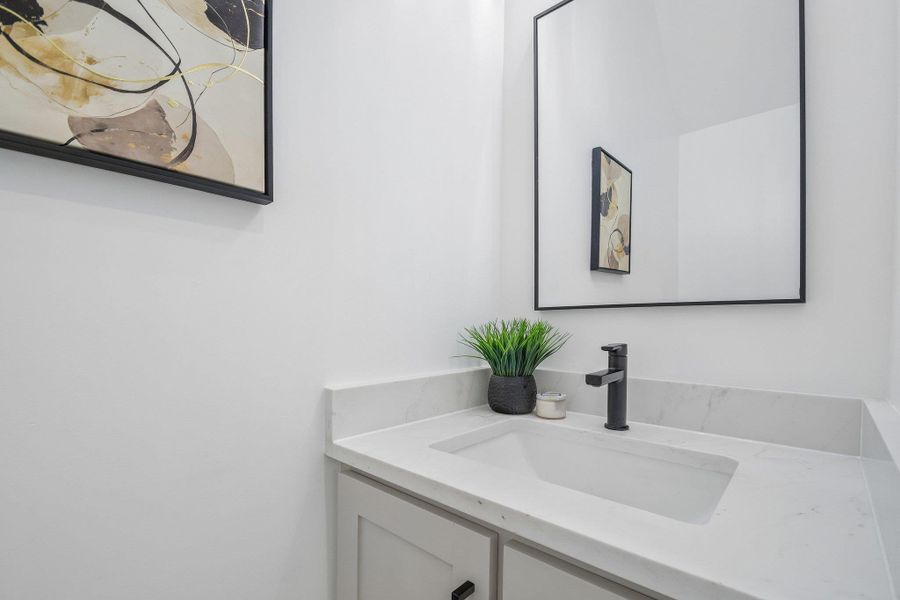 Clean lines and a stone-topped vanity define this modern powder room. Clean lines and a stone-topped vanity define this modern powder room.