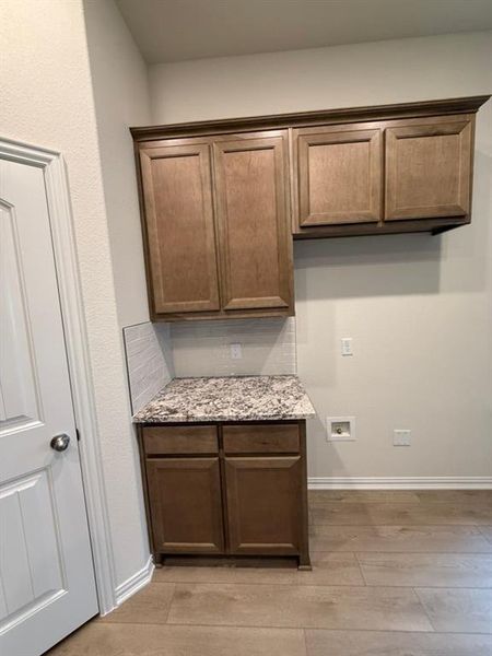 Laundry area with hookup for a washing machine and cabinet space Laundry area with hookup for a washing machine and cabinet space