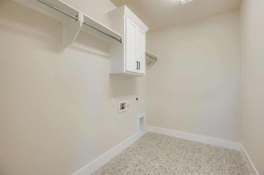 Washroom featuring hookup for an electric dryer, cabinet space, and hookup for a washing machine