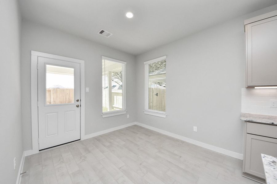 Enjoy breakfast with ease in the connected and cozy breakfast area, seamlessly integrated with the kitchen for utmost convenience. Step through the back door for a breath of fresh air onto the covered patio, extending your living space to the outdoors. Sample photo of completed home with similar floor plan. Actual colors and selections may vary. Enjoy breakfast with ease in the connected and cozy breakfast area, seamlessly integrated with the kitchen for utmost convenience. Step through the back door for a breath of fresh air onto the covered patio, extending your living space to the outdoors. Sample photo of completed home with similar floor plan. Actual colors and selections may vary.