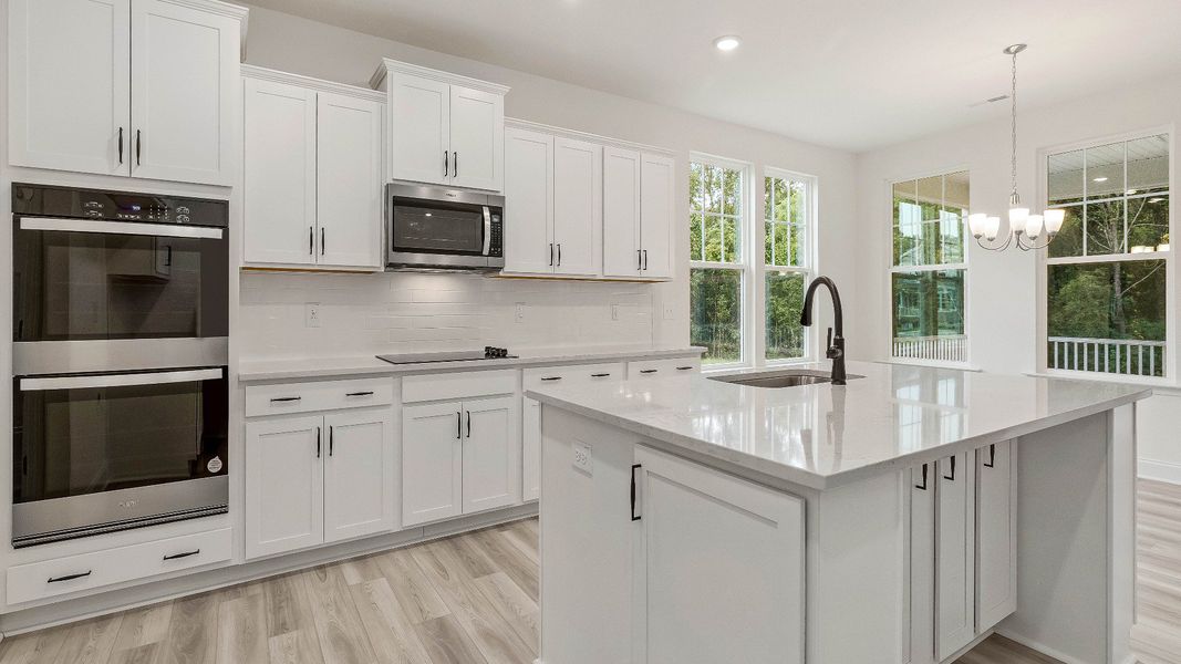 Stonehaven home plan kitchen with large island, ample cabinetry and butler's pantry with adjoining breakfast area Stonehaven home plan kitchen with large island, ample cabinetry and butler's pantry with adjoining breakfast area