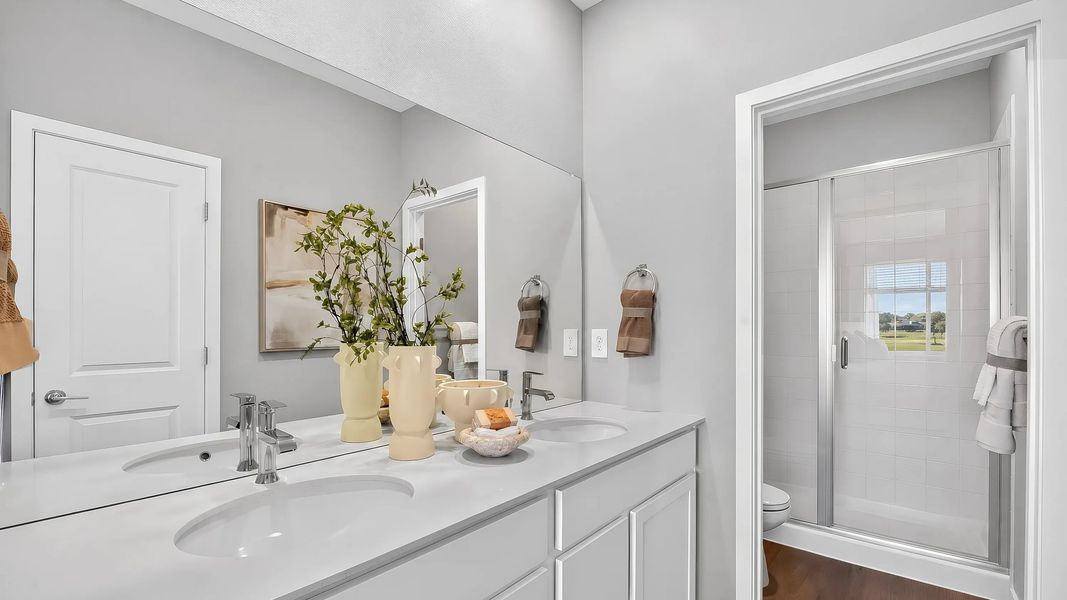 En-suite bathroom with double sinks and shower En-suite bathroom with double sinks and shower