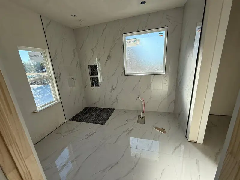 Unfurnished room featuring marble tiled floors Unfurnished room featuring marble tiled floors
