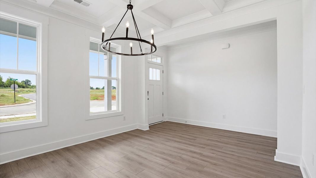 Coffered ceiling detail brings depth and sophistication to this top-notch formal dining room