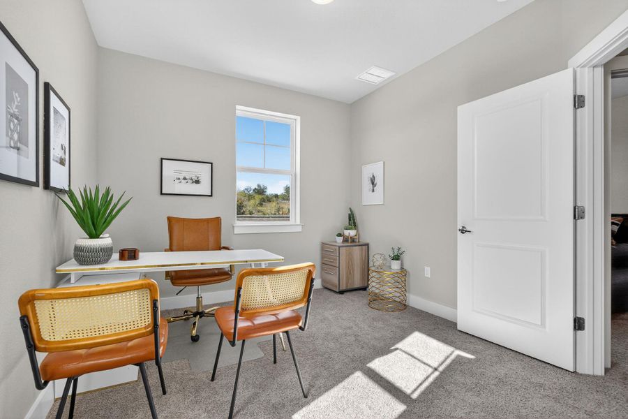 Home office with carpet flooring and baseboards