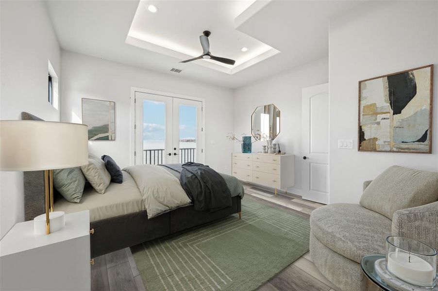 Upstairs guest bedroom with a raised ceiling, access to lakefront balcony, LED lit tray ceilings, with en suite bathroom and walk-in closet. (Bedroom 3 of 5)