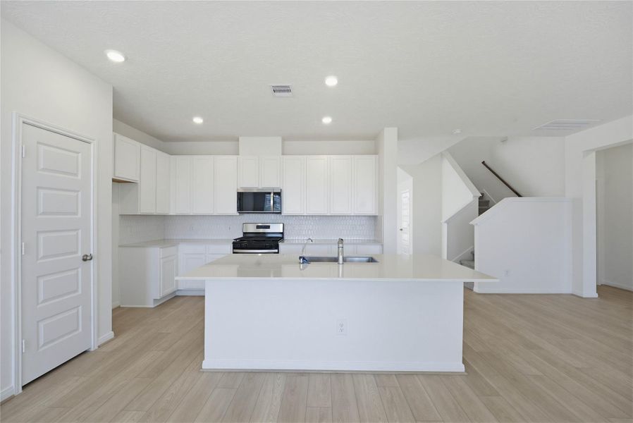 This spacious kitchen has it all—ample storage, generous counter space, and a layout that truly makes it the heart of the home.