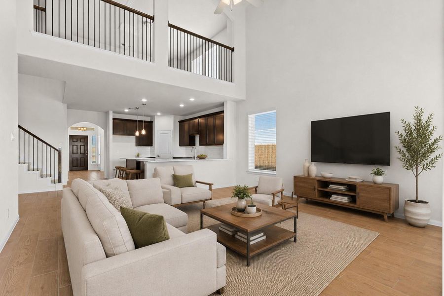 Another expansive view of the family room highlighting the incredible open concept design that connects the living area with the gourmet kitchen and dining space. Large windows bring in natural light while the beautiful wood looking tile flooring enhances the warmth and style of the main living area. *Photo is Virtually Staged*