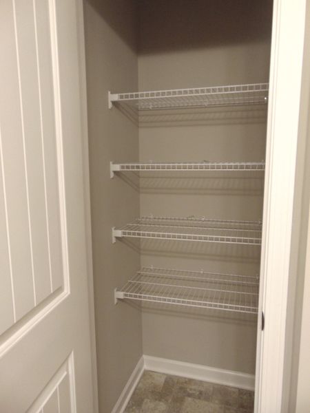 The primary bedroom comes with a modern shower, two sinks, and an elongated toilet, as well as a linen closet