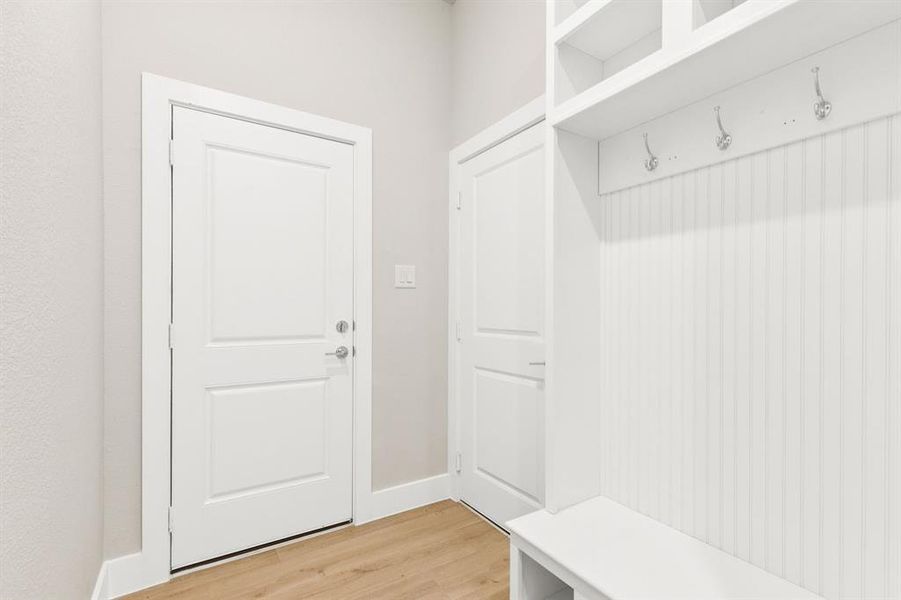 Full bathroom featuring double vanity, light marble finish flooring, and a marble finish shower Full bathroom featuring double vanity, light marble finish flooring, and a marble finish shower